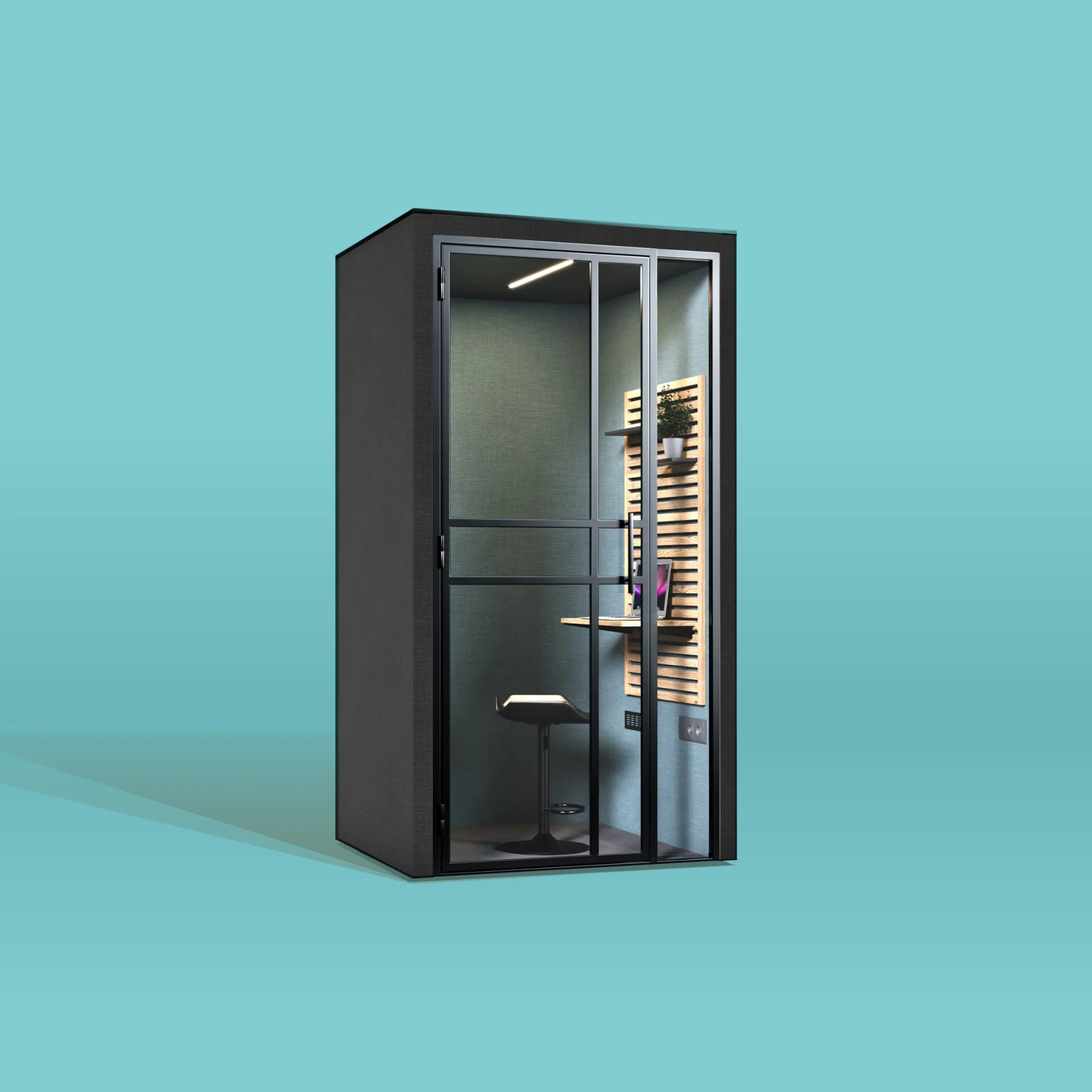 Een zwarte HalloPod 1 XL belcabine voor korte telefoontjes van het merk CoGa met een blauw-groen interieur met een in hoogte verstelbaar tafelblad