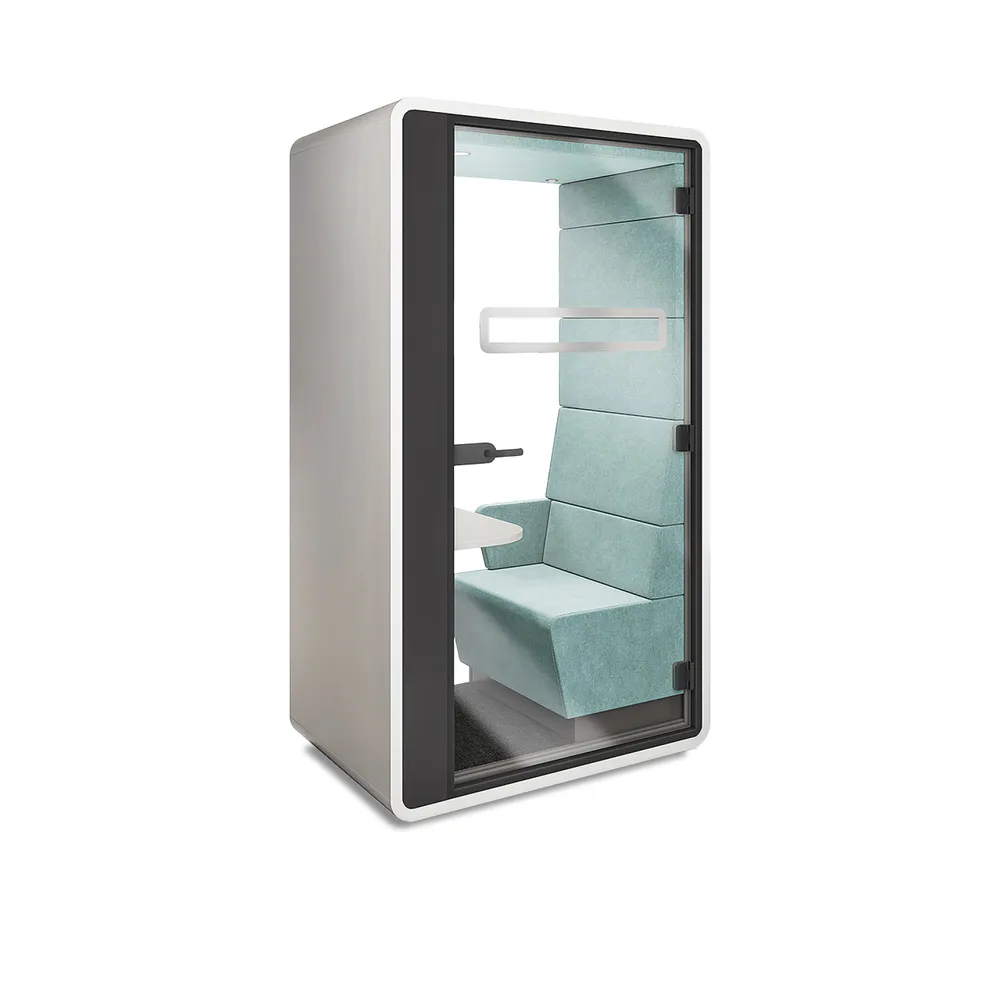 Een witte HushHybrid videobelcabine van Mikomax met een grijs-groen interieur met daarin een vast tafelblad en allerlei aansluitmogelijkheden